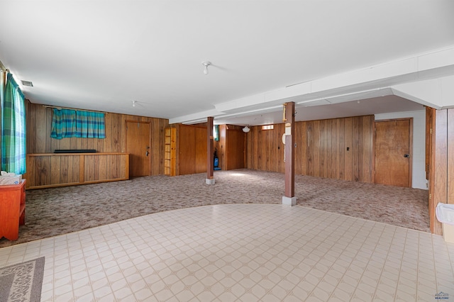 basement with wooden walls and carpet floors