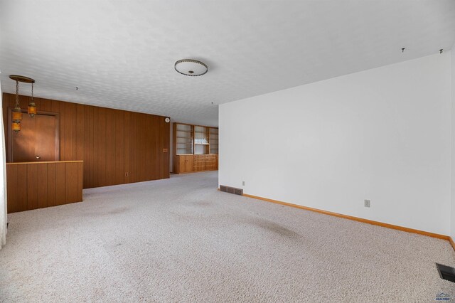 spare room with carpet floors and a textured ceiling