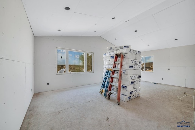 interior space featuring vaulted ceiling and plenty of natural light