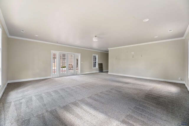 spare room with carpet flooring, ornamental molding, and french doors