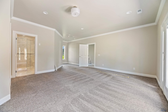 unfurnished room with ornamental molding and carpet flooring