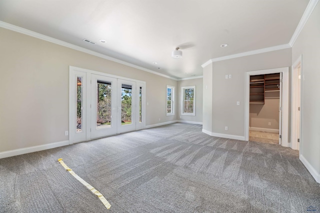 spare room featuring crown molding, french doors, and carpet flooring