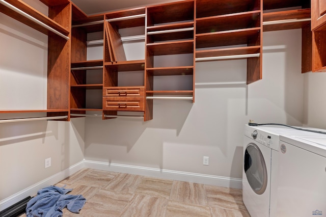 walk in closet with separate washer and dryer