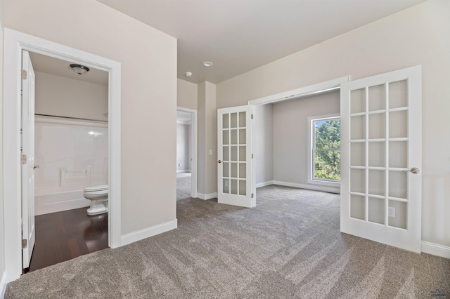 empty room featuring hardwood / wood-style floors and french doors