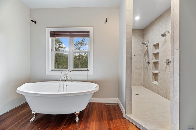 bathroom with wood-type flooring and separate shower and tub