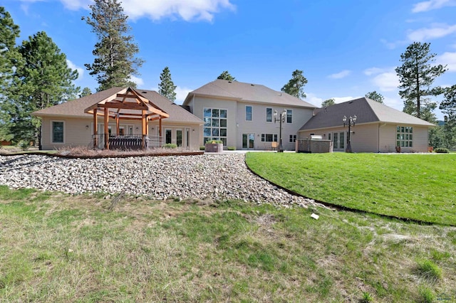 rear view of house featuring a yard and a pergola