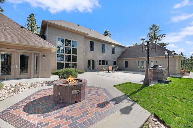 back of property featuring a patio area, a fire pit, and french doors