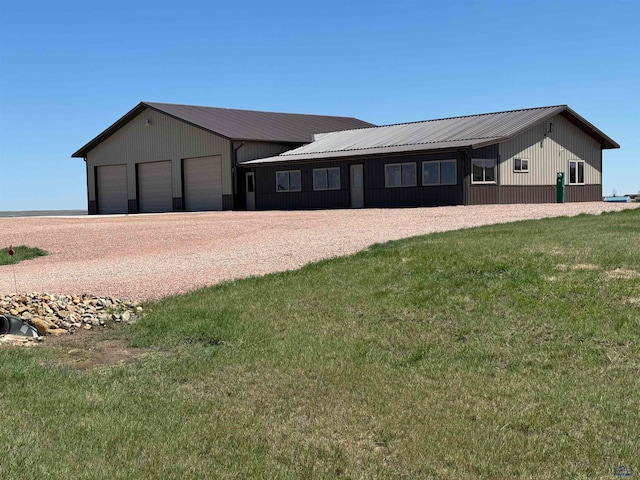 single story home featuring a garage and a front lawn