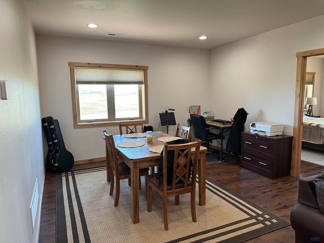 dining space with dark hardwood / wood-style flooring