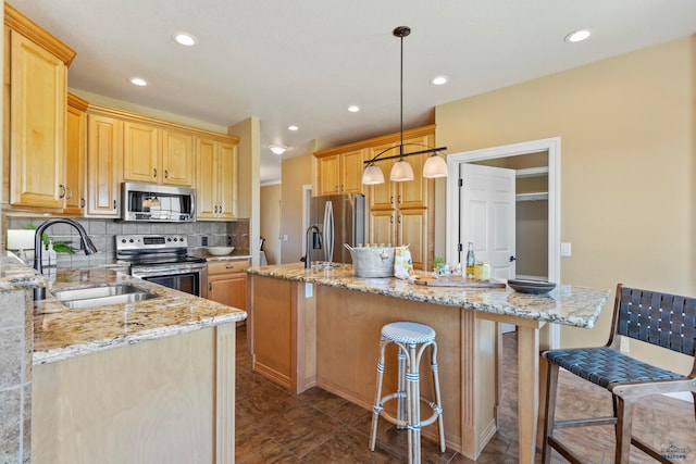 kitchen with dark tile floors, backsplash, hanging light fixtures, appliances with stainless steel finishes, and sink