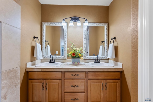 bathroom featuring oversized vanity and dual sinks