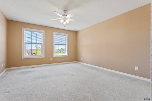 carpeted empty room featuring ceiling fan