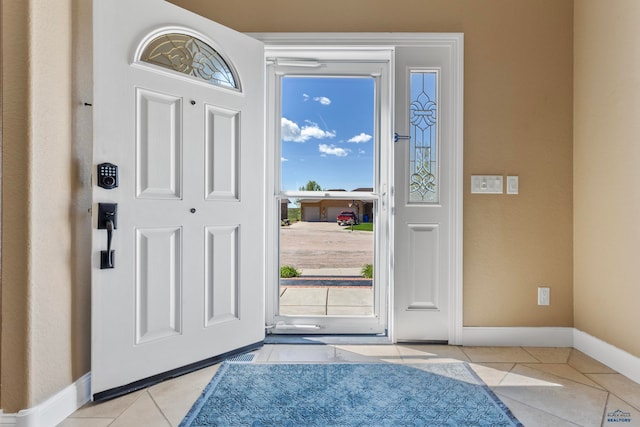 entryway with a healthy amount of sunlight and light tile flooring