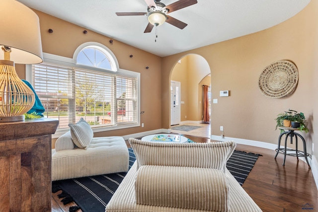 living room with plenty of natural light, ceiling fan, and dark hardwood / wood-style flooring