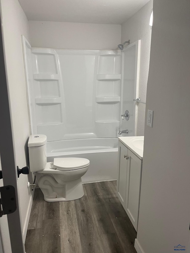 full bathroom featuring vanity, hardwood / wood-style flooring, toilet, and tub / shower combination