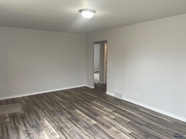 empty room with dark wood-type flooring