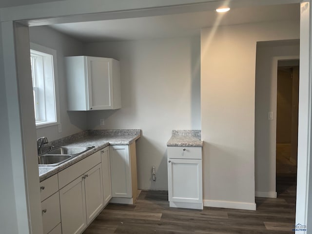 kitchen featuring sink, white cabinets, and dark hardwood / wood-style floors