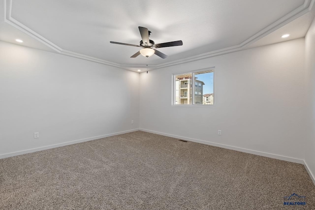 carpeted spare room featuring ornamental molding and ceiling fan