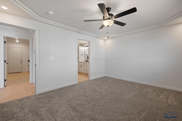 unfurnished bedroom with light carpet, ceiling fan, crown molding, and connected bathroom