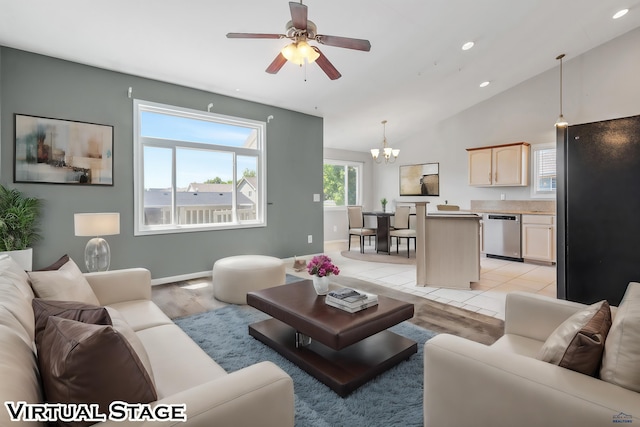 tiled living room featuring ceiling fan with notable chandelier and lofted ceiling