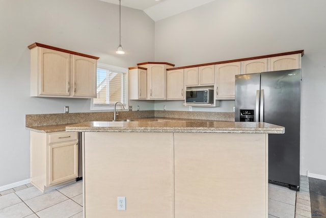 kitchen with stainless steel fridge with ice dispenser, light tile patterned floors, a kitchen island, and pendant lighting