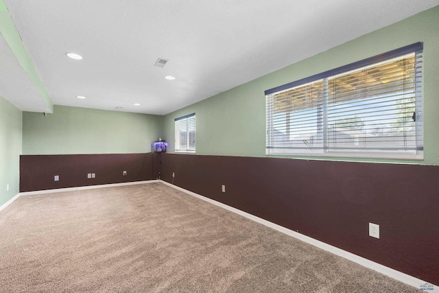 carpeted empty room with a wealth of natural light