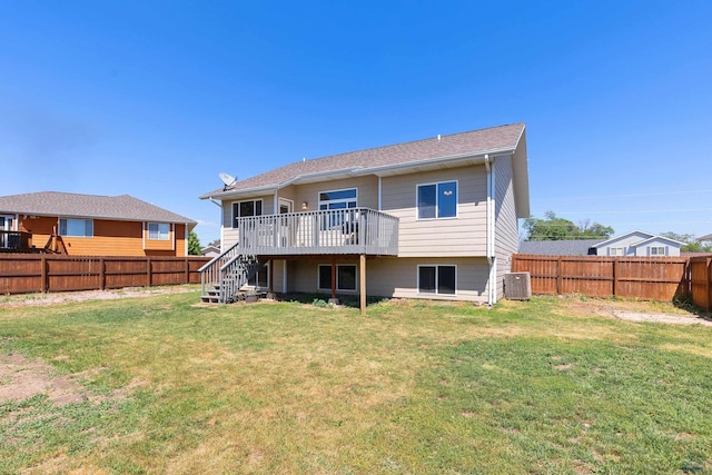 rear view of property with a yard, a deck, and central air condition unit