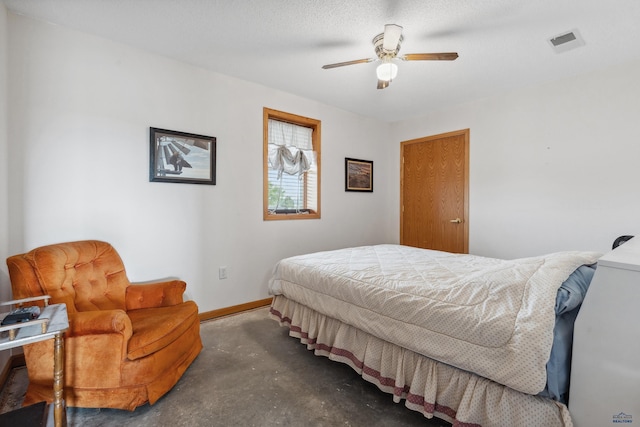 bedroom with ceiling fan and a textured ceiling