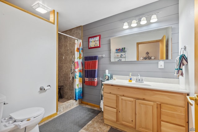 bathroom featuring tile flooring, vanity, toilet, and curtained shower