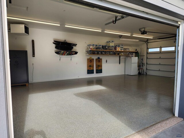 garage with white refrigerator and a garage door opener