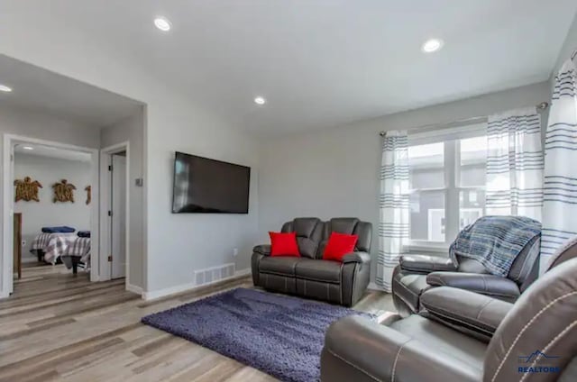 living room with light hardwood / wood-style floors