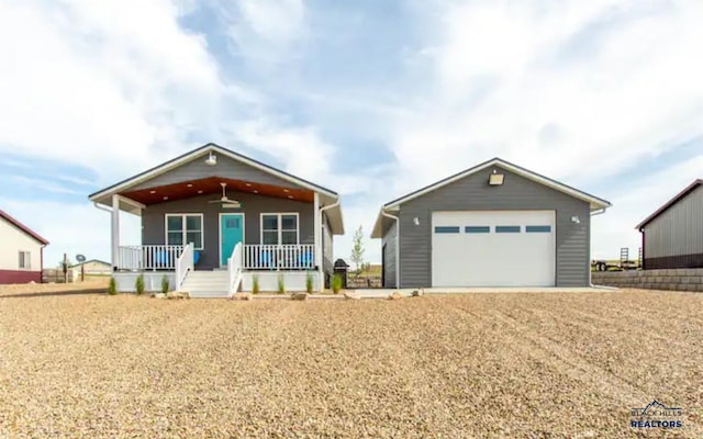 view of front of property with an outbuilding, a porch, and a garage