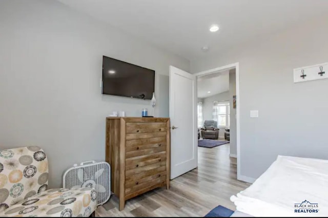 sitting room with light hardwood / wood-style flooring and vaulted ceiling