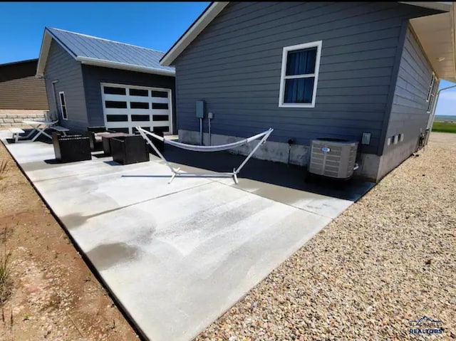 rear view of house featuring an outdoor living space, a patio, and central air condition unit