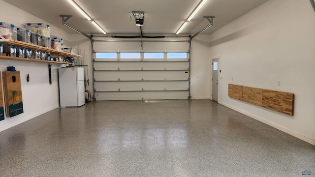 garage featuring a garage door opener and white refrigerator