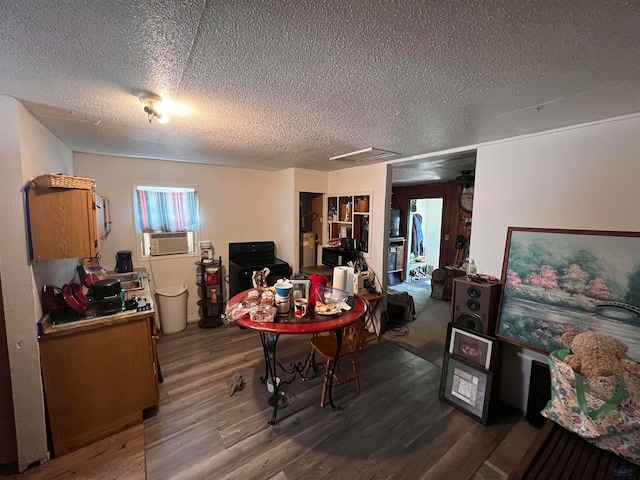 office space featuring cooling unit, a textured ceiling, and hardwood / wood-style floors