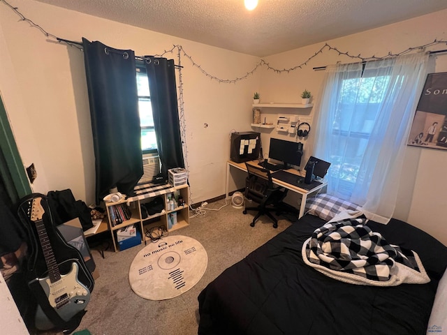 bedroom with multiple windows, a textured ceiling, and carpet flooring