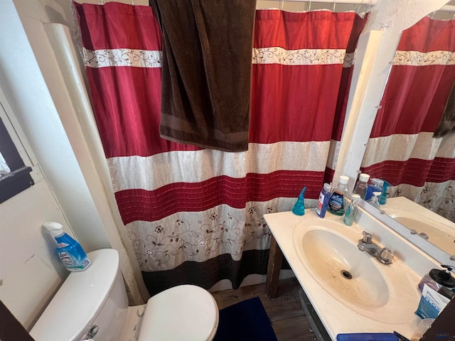 bathroom featuring sink, hardwood / wood-style flooring, and toilet