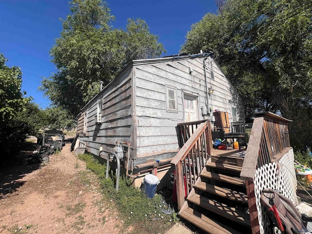 view of side of property with a wooden deck