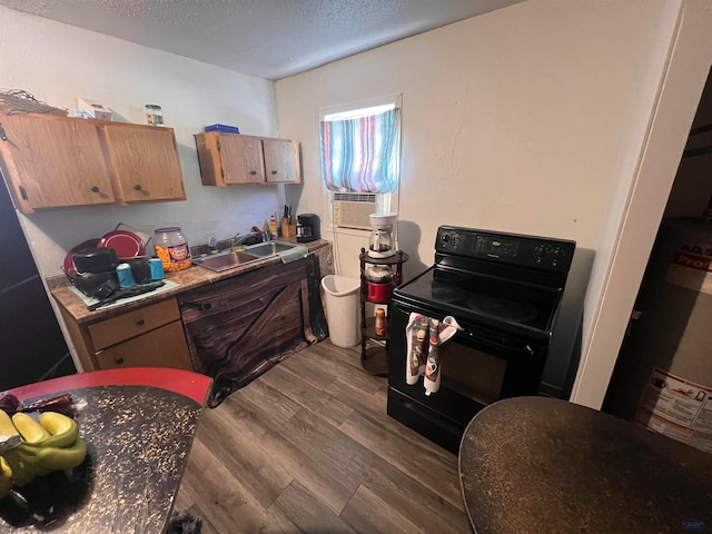 kitchen featuring a textured ceiling, sink, black / electric stove, and hardwood / wood-style floors