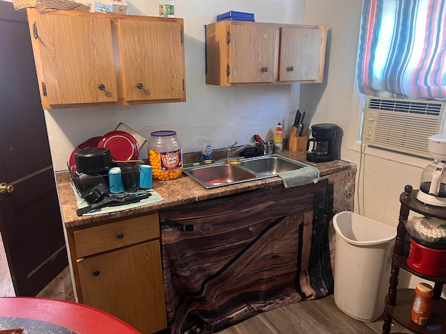 kitchen featuring sink, hardwood / wood-style flooring, and cooling unit