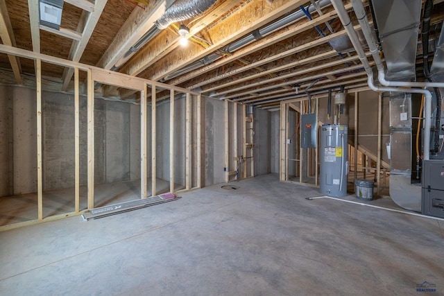 basement featuring electric water heater, heating unit, and electric panel