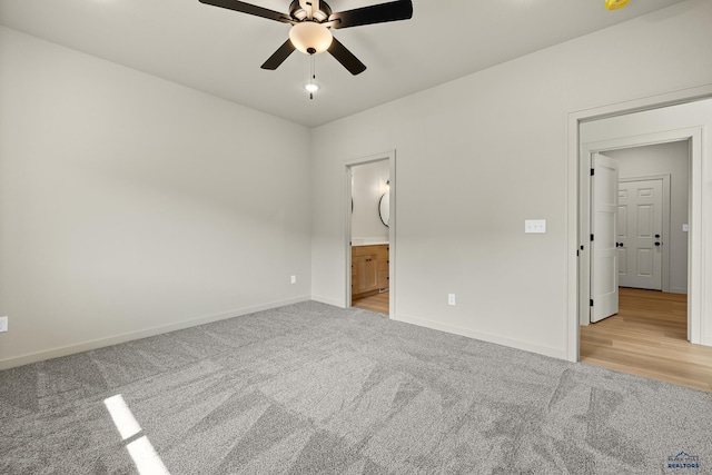 unfurnished bedroom with light carpet, ensuite bath, and ceiling fan