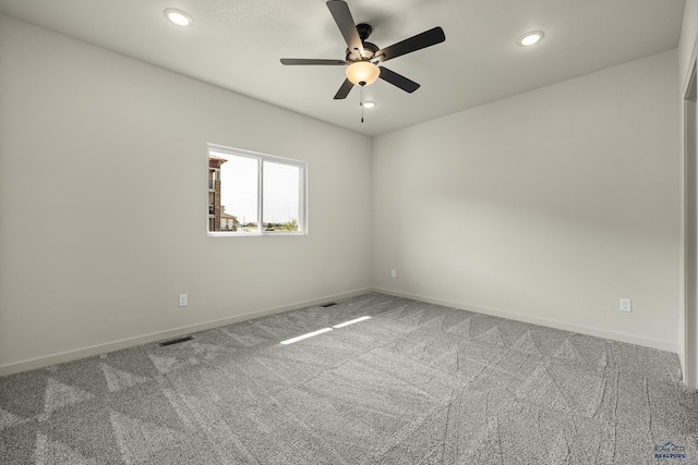 carpeted spare room featuring ceiling fan