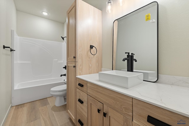 full bathroom featuring vanity, shower / bathing tub combination, wood-type flooring, and toilet