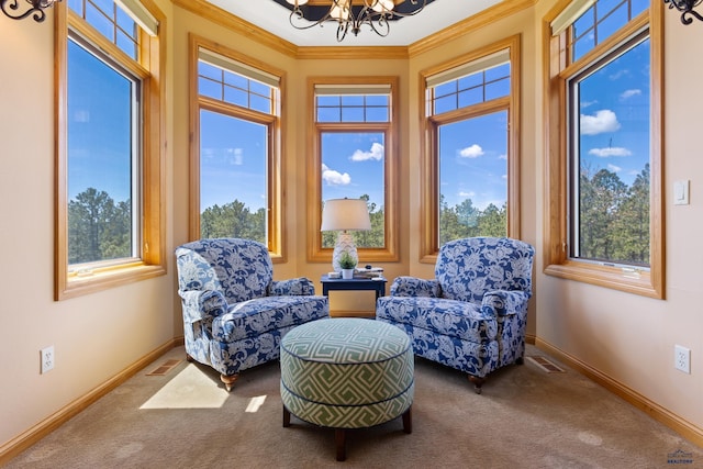 living area with crown molding, carpet floors, and an inviting chandelier