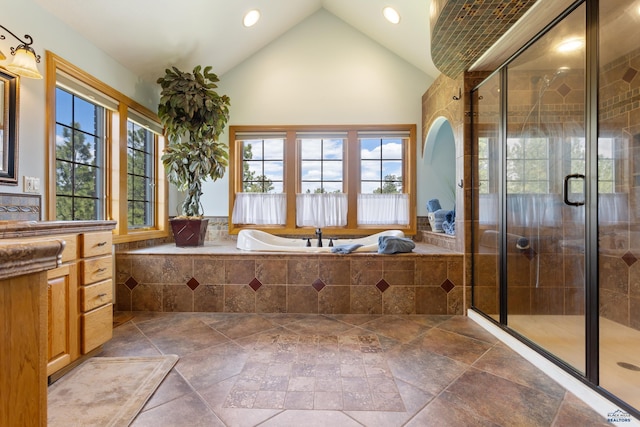 bathroom with vanity, high vaulted ceiling, and separate shower and tub