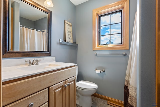 bathroom featuring vanity and toilet