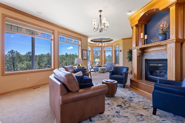 carpeted living room featuring crown molding, a fireplace, and an inviting chandelier