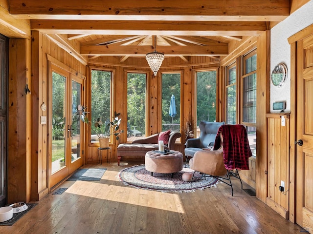 sunroom featuring an inviting chandelier, french doors, and vaulted ceiling with beams